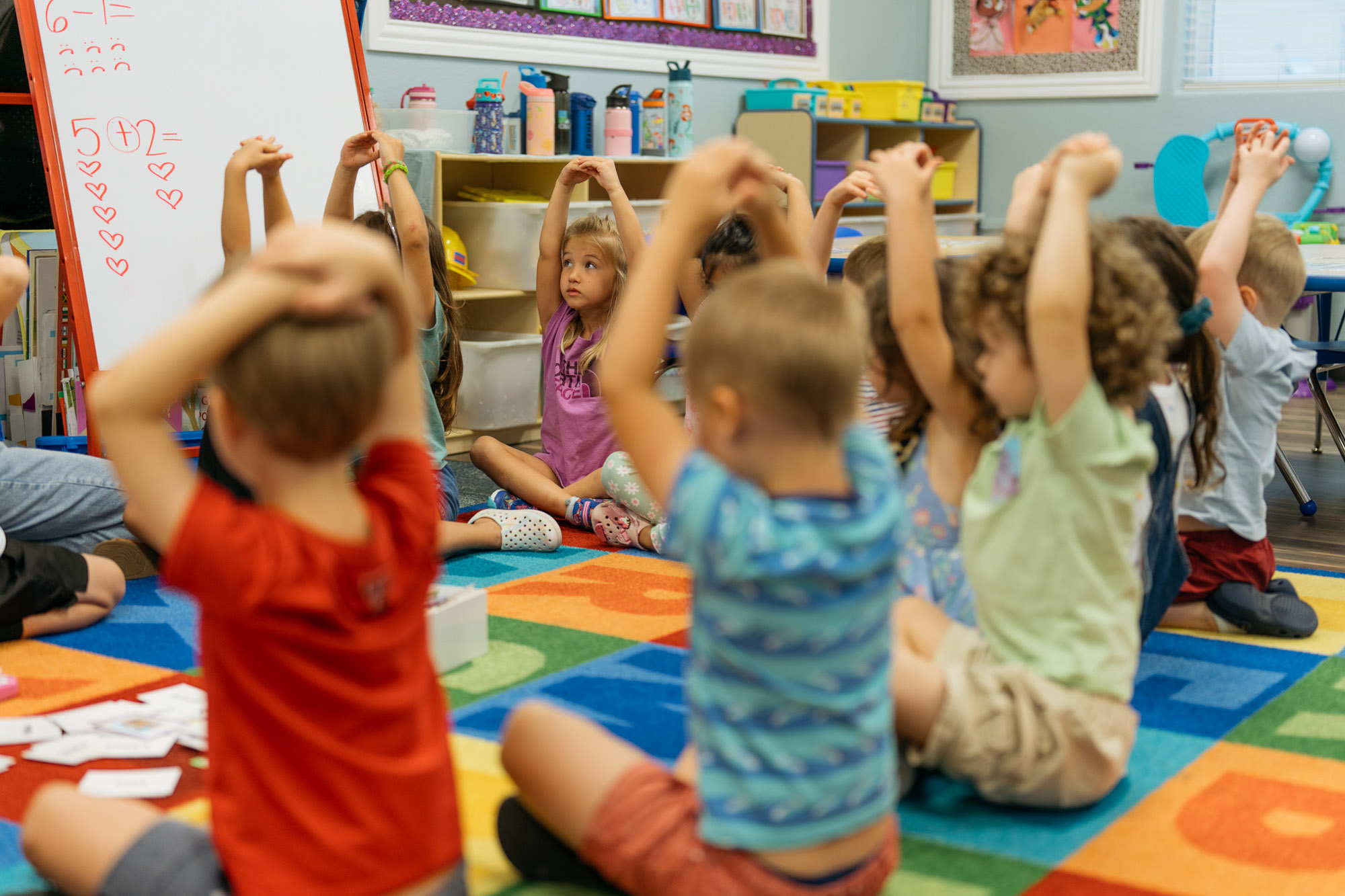 children sitting in a circle learning.